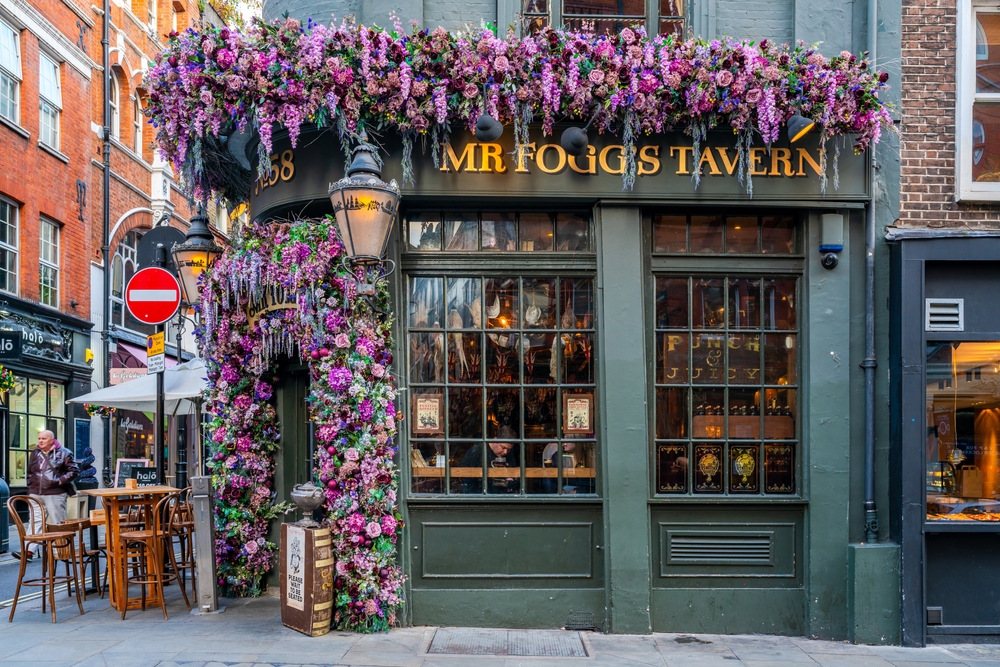 this bar in Covent Garden has purple flowers surrounding the front door.