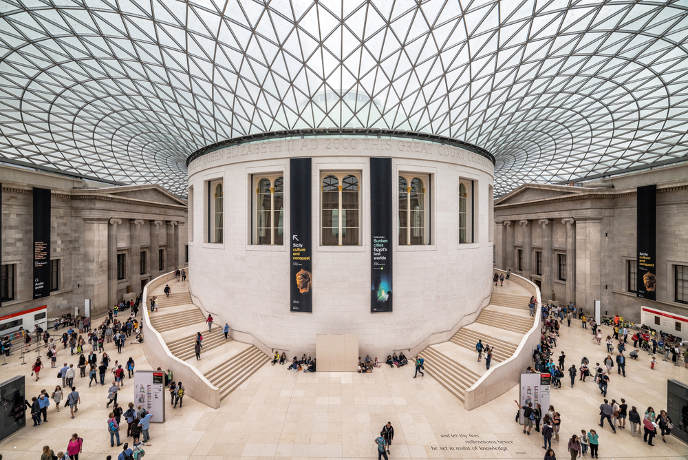 Tourists in the Great Court at the British Museum. Museum was designed by architect Lord Norman Foster. There is a huge ceiling and it's a vast space. 