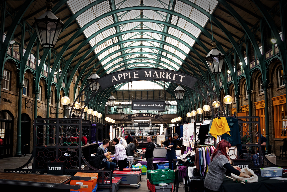 Apple market in Covent Garden in London. Showing the market with stall holders setting up their items. 