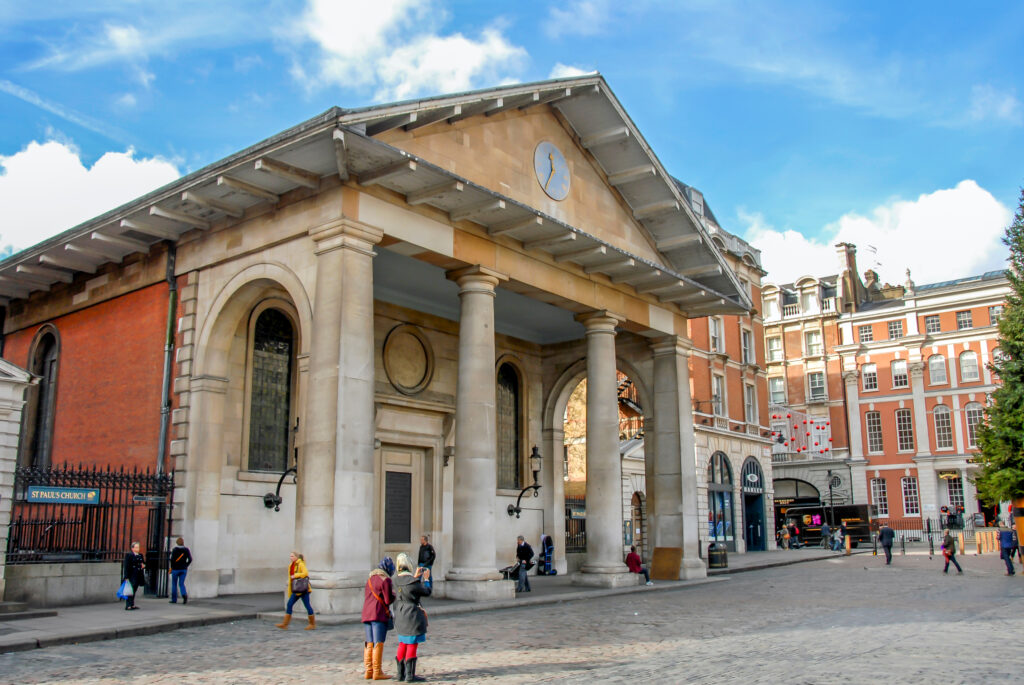 A photo of St Paul's Church. It is taken fomr the side and there are people on the street.  