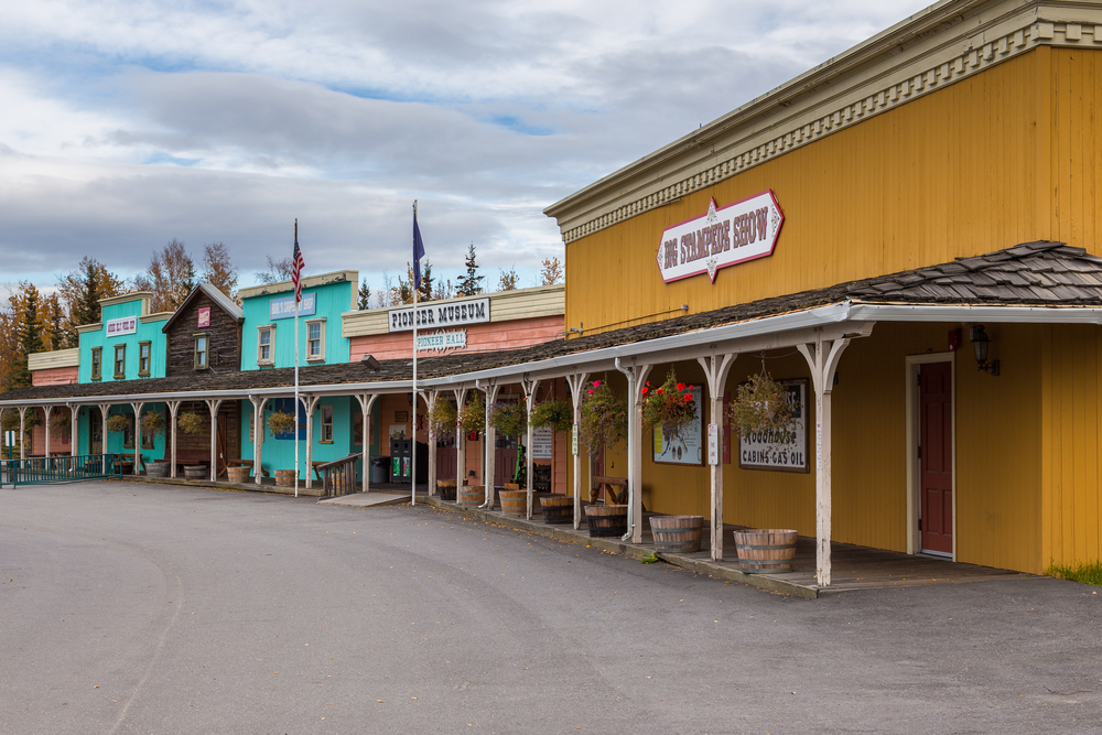 Historical Buildings in Pioneer Park. The builds are yellow pink and blue and wooden.