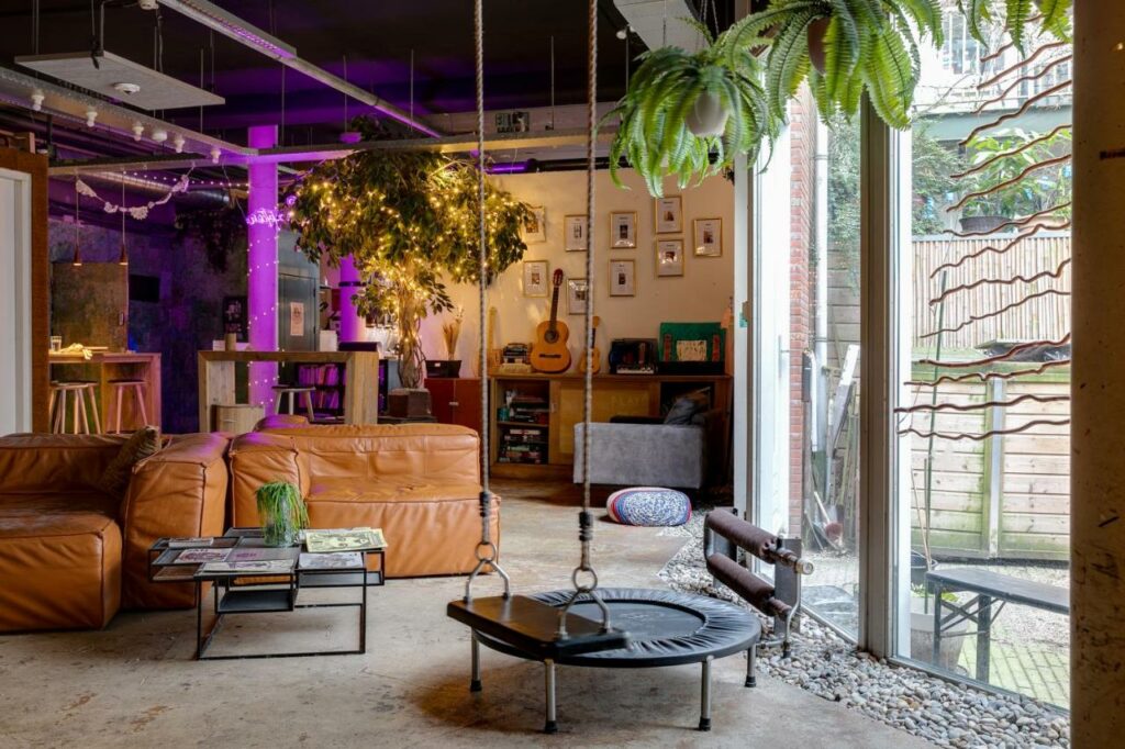 Chic lounge with many seating options at Ecomama, one of the best hostels in Amsterdam.