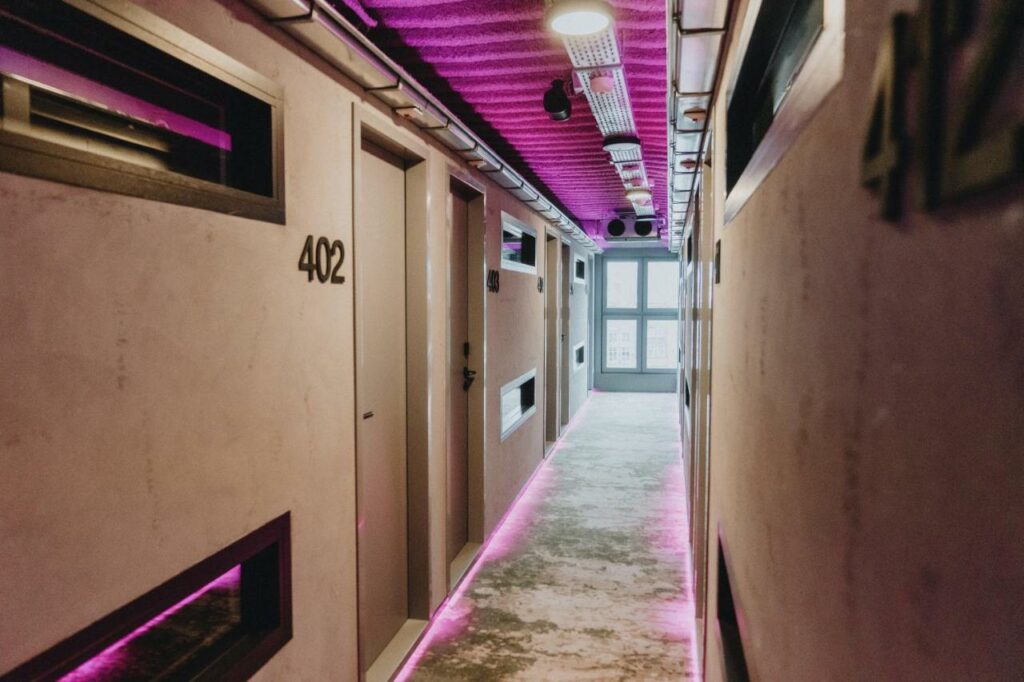 Hallway at THIS HO(S)TEL with purple lights.