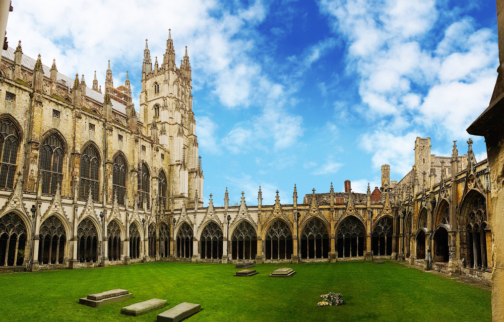 Canterbury Cathedral Cloister, Kent, United Kingdom. There is a green area in the middle. 