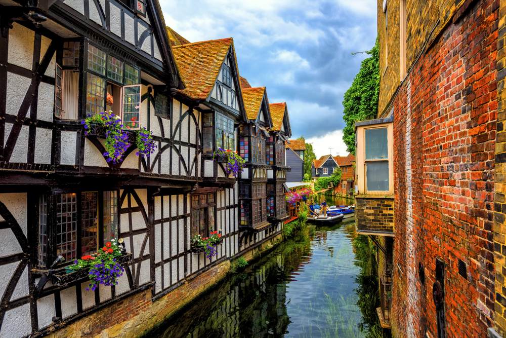 Medieval half-timber houses and Stour river in Canterbury Old Town, Kent, England. The article is about day trips from London by train 