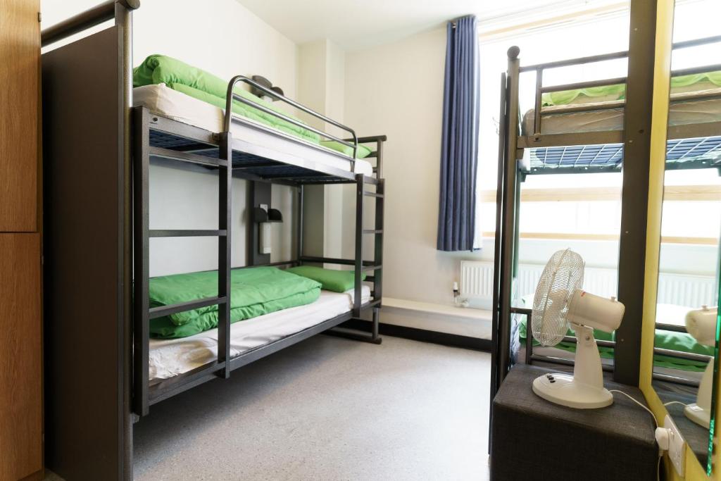 Bunk bed with green and white bedding best hostels in london