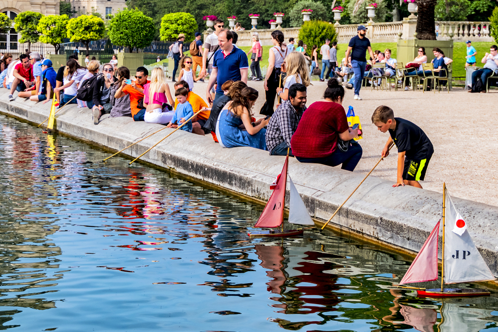 Kids pushing sailboats in the basin in the Jardin du Luxembourg.