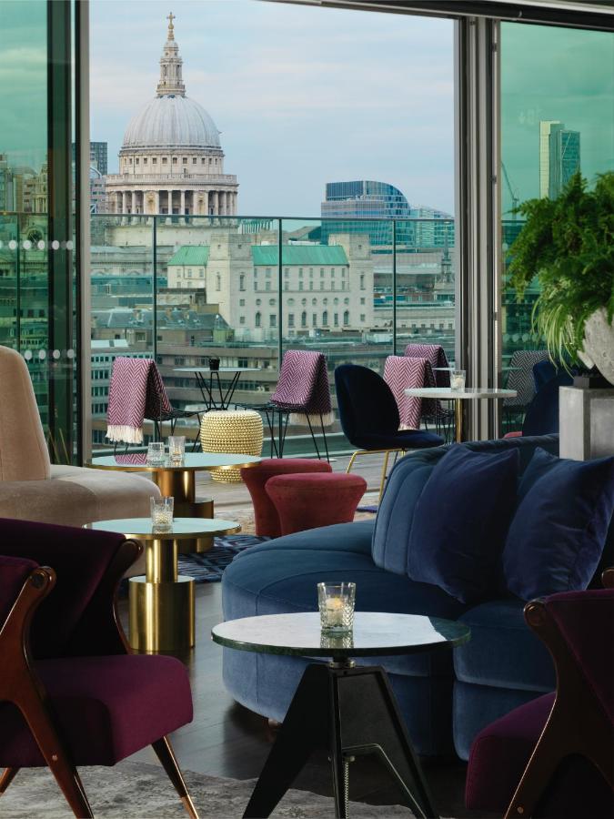 View of St. Paul's Cathedral out a window on a rooftop bar in London.