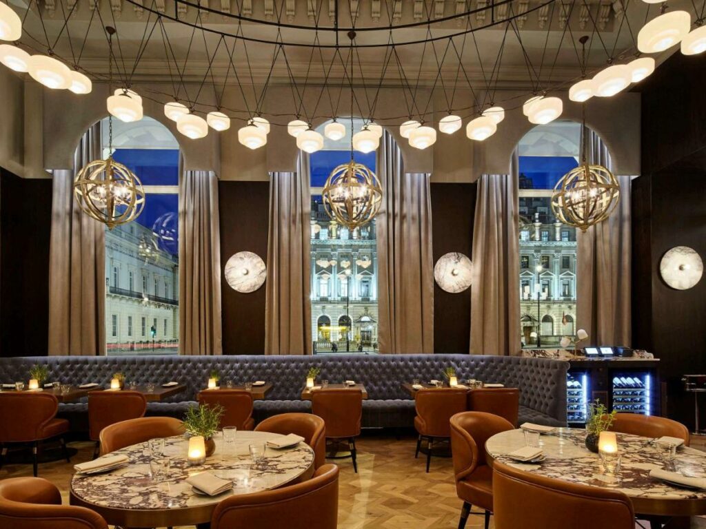 Elegant dining room with fancy light fixtures at the Sofitel London St James.
