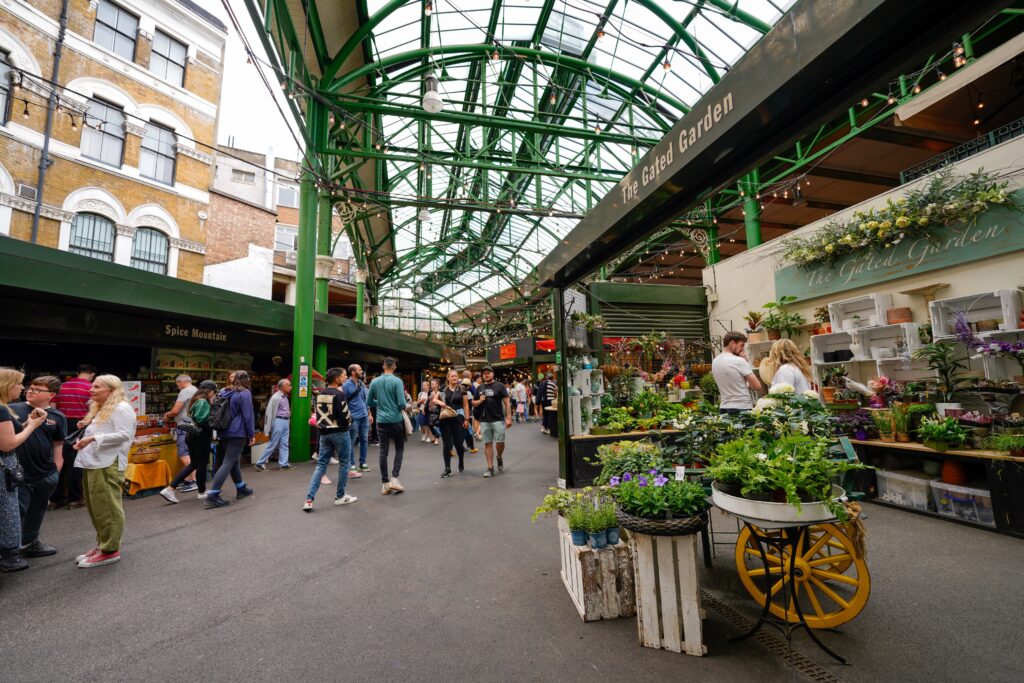 Borough Market, located at the Southern end of the London Bridge, is London's oldest and largest food market. The architecture and food is amazing. The photo show people walkign aroudn the market