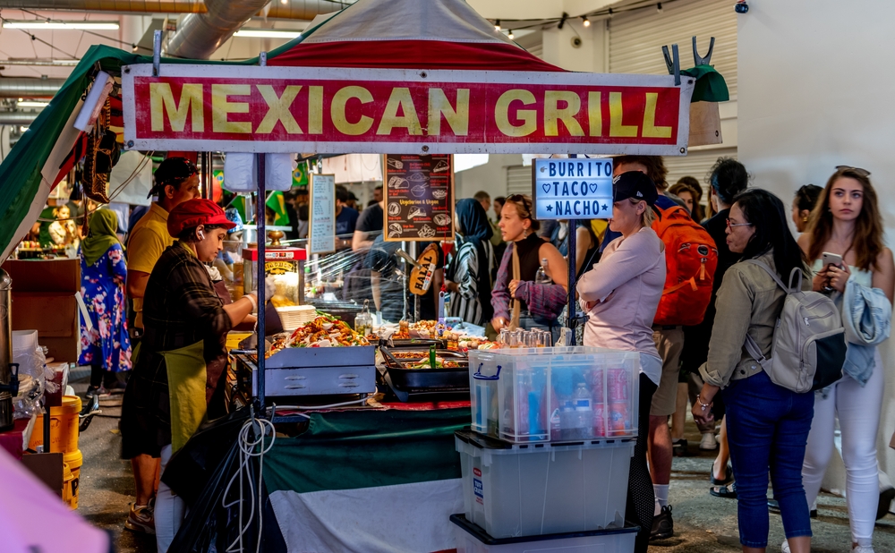 Interior view of Upmarket in Brick Lane showing the crowd of tourists and visitors to its many food stalls.