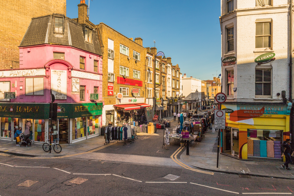 A view of petticoat lane market in London. The market runs down the middle of two streets, 