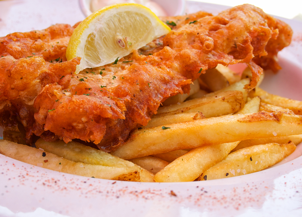 A plate of fish and chips . The article is about the best walks in London. 