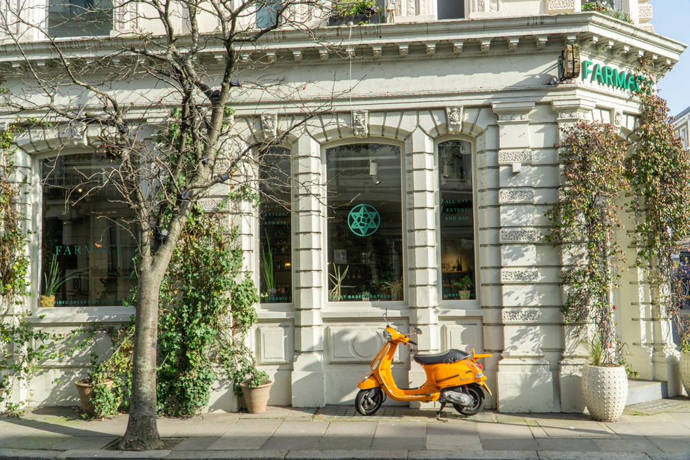 Orange moped outside 'Farmacy', Westbourne Grove, London. One of the places to get brunch in Kensington 