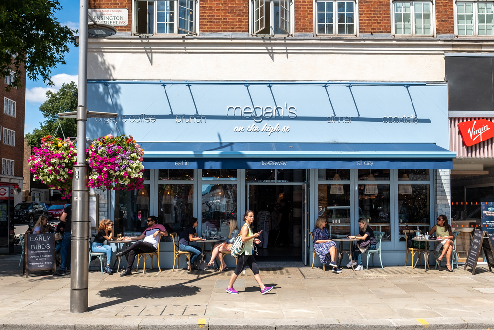 eople sitting outside Megan's restaurant on Kensington High Street in West London. One of the places to get brunch in Kensington 