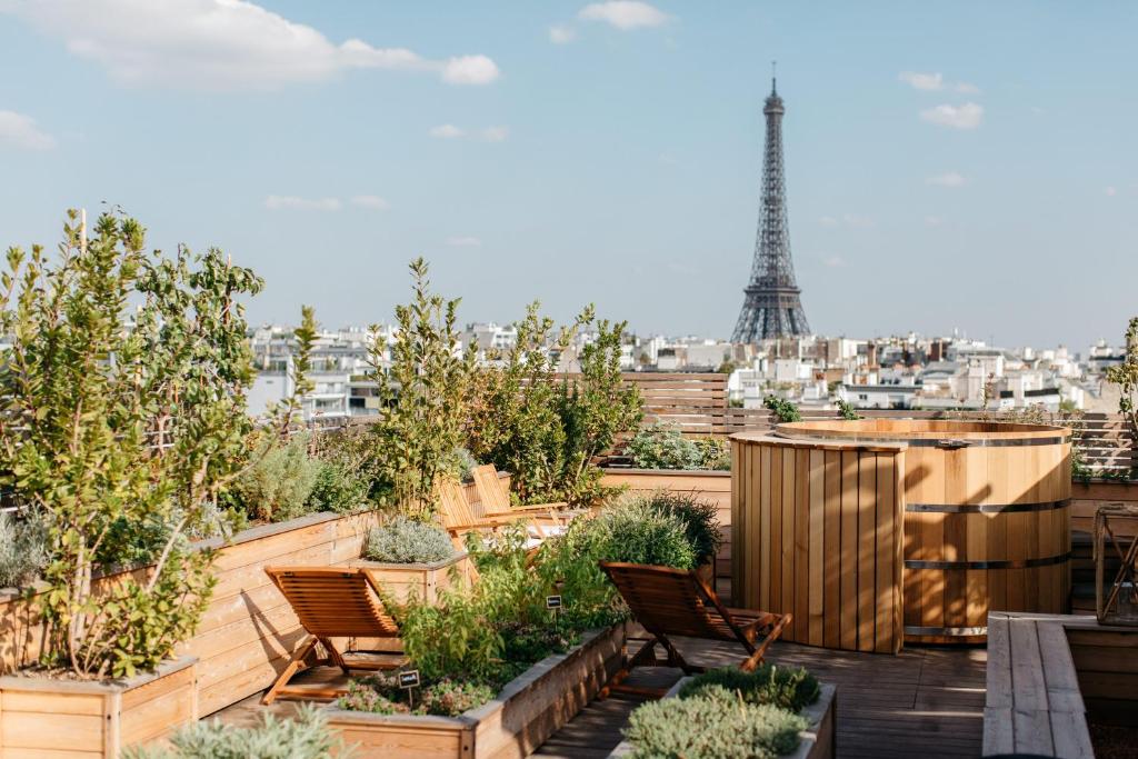 A view of the Eiffel Tower in the Distance, with wooden chairs, and a sauna.