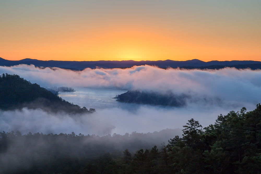 Cloudy sunrise over Broken Bow Lake, one of the best Midwest weekend getaways.