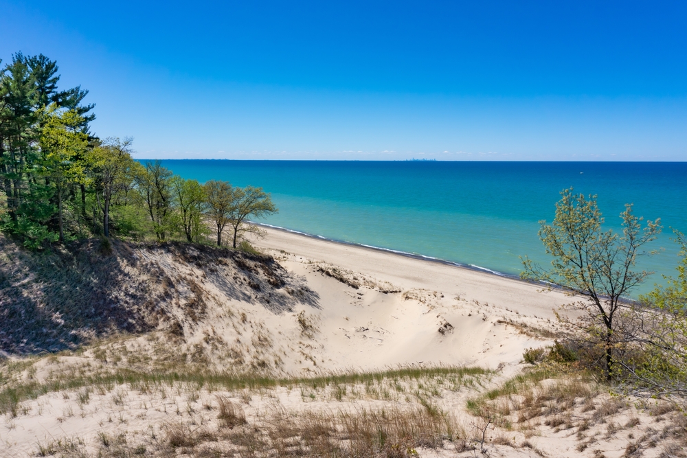 Clear, sunny day over sand dunes and Lake Michigan.