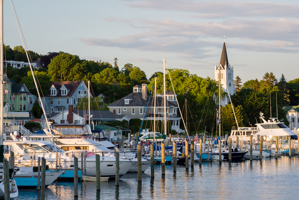 View of Mackinac Island across the harbor filled with boats.