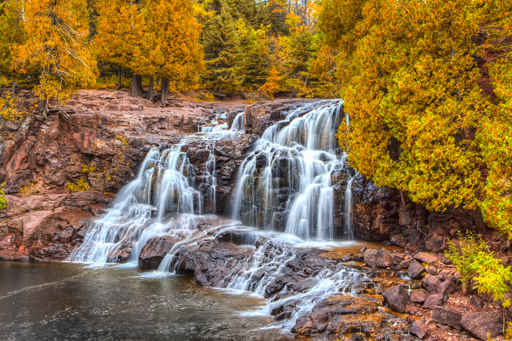 Fall day at a gushing waterfall in Gooseberry Falls State Park.