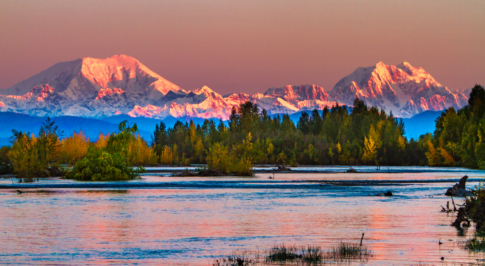 Pink dusk over mountains and lake in Denali National Park.