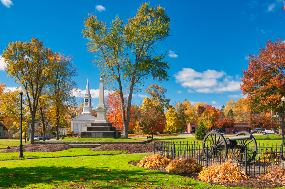 Sunny fall day in a park in Twinsburg with a white church in the background.