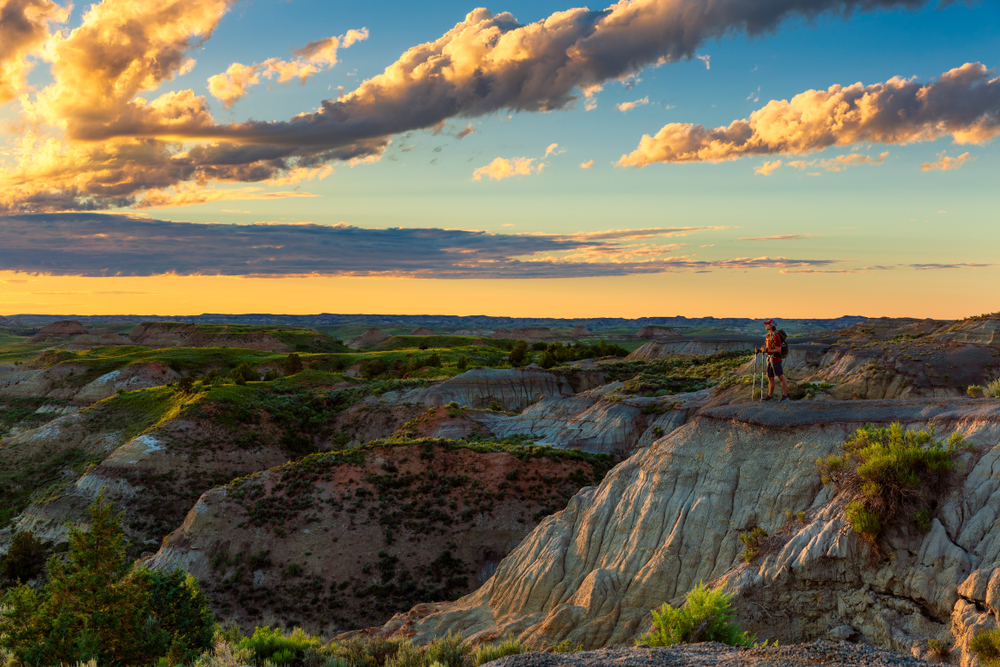 A person looking out over the badlands  one of the romantic getaways in Midwest. 