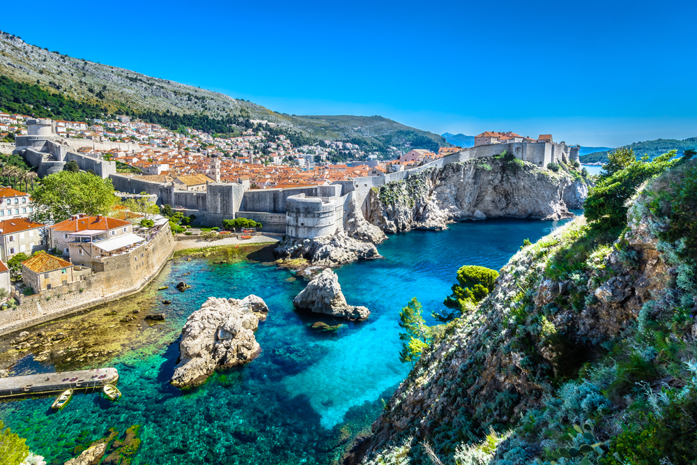 View of bright blue water and rugged coast along Dubrovnik, Croatia.