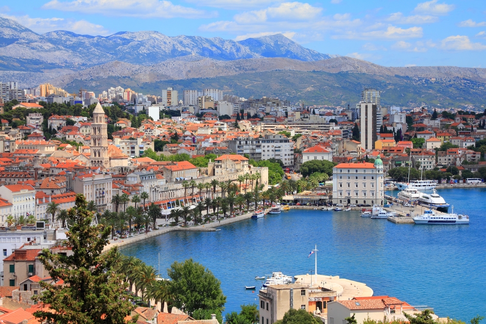 Panoramic view of Split featuring the waterfront and mountains in the distance.