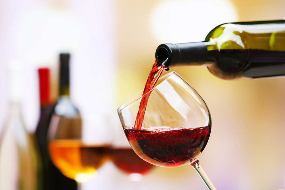 Red wine being poured into a wine glass.