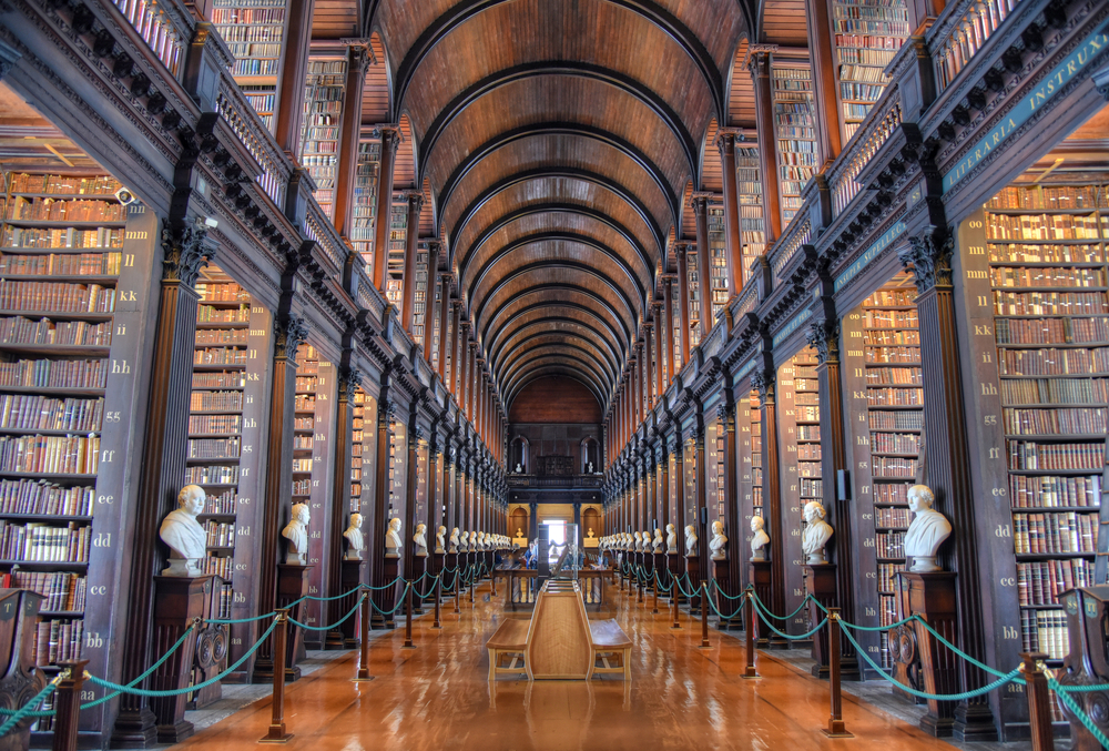 The Long Room in the Old Library at Trinity College Dublin. You can see lots of old books and busts. 