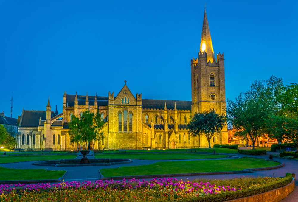 Night view of the St. Patrick's Cathedral with flowers out the front. One of the places to go on your 2 days Dublin itinerary