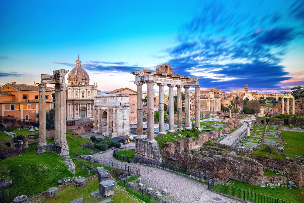 Sunset over the Roman Forum with many ruins, columns, and arches seen during Rome in a day.