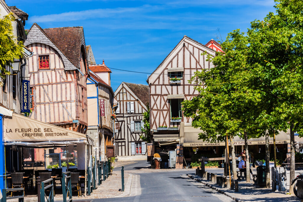 Street scene with old houses in the medieval town of Provins. The article is about day trips from Paris by train.