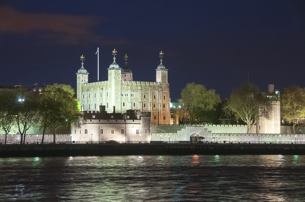 Tower of London at night all lit up from across the water. 