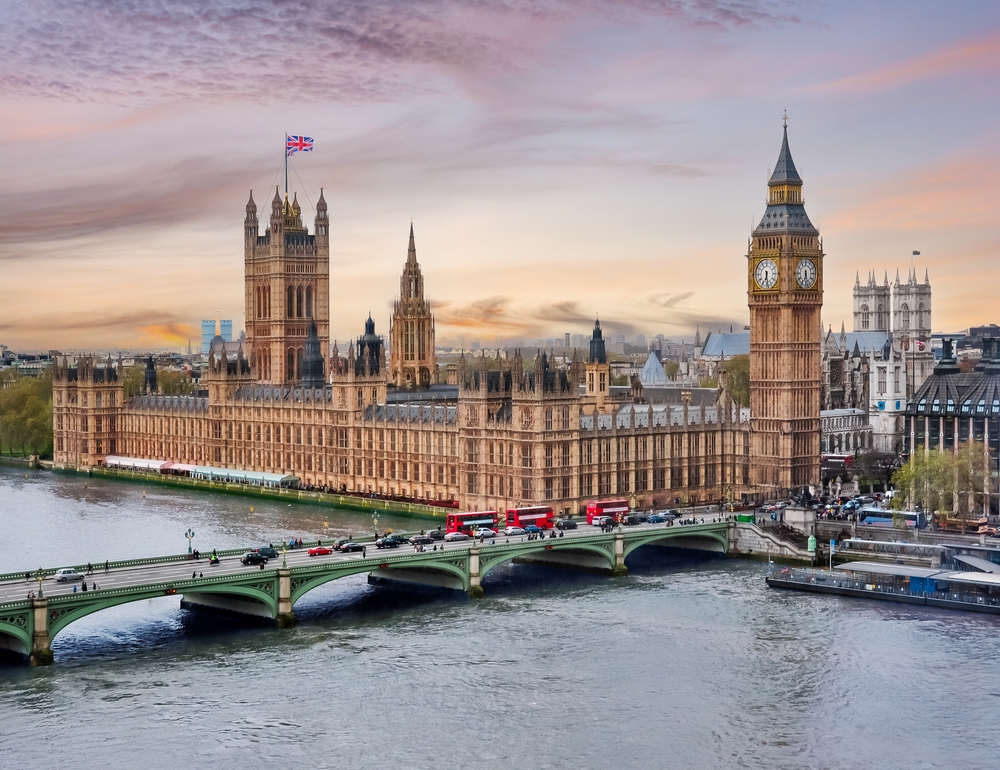 London cityscape with Houses of Parliament and Big Ben tower at sunset, UK. The article is about one day in London. 