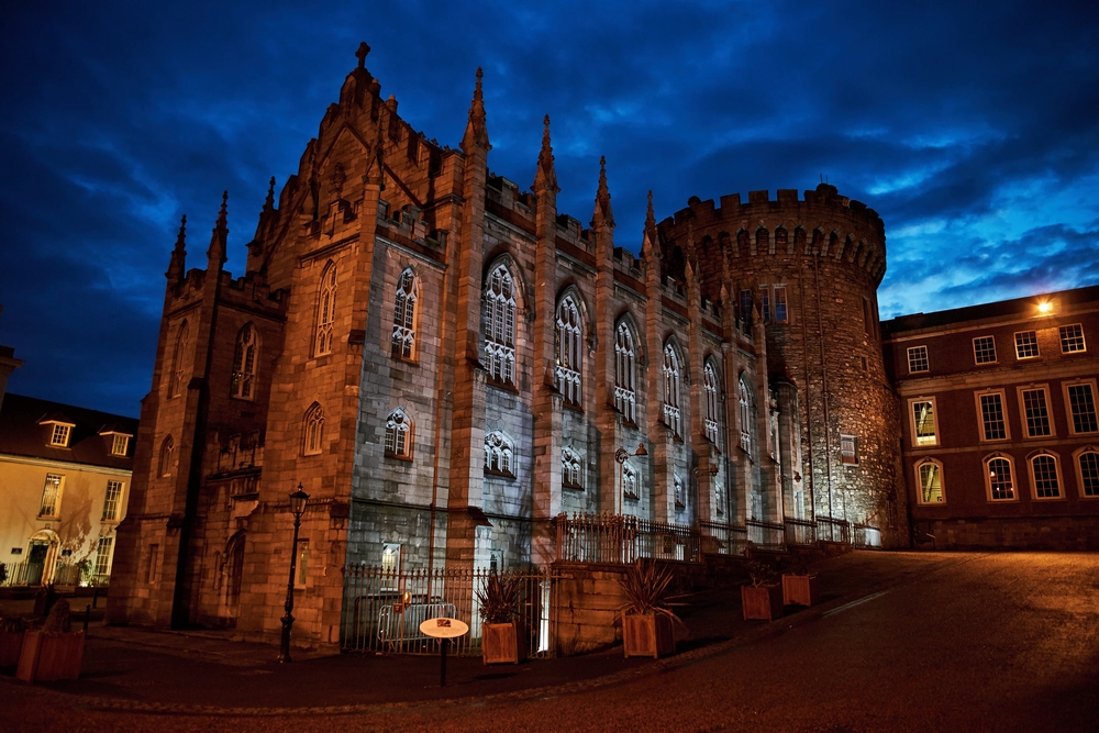 Dublin Castle in the night. The castle is lit up and the sky is atmosphic.  