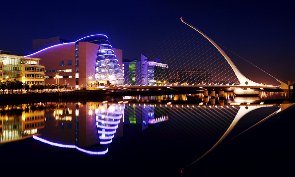 Barrel shaped Dublin Convention Center (The CCD) and Samuel Beckett Bridge by architect Santiago Calatrava reflecting in the river Liffey 