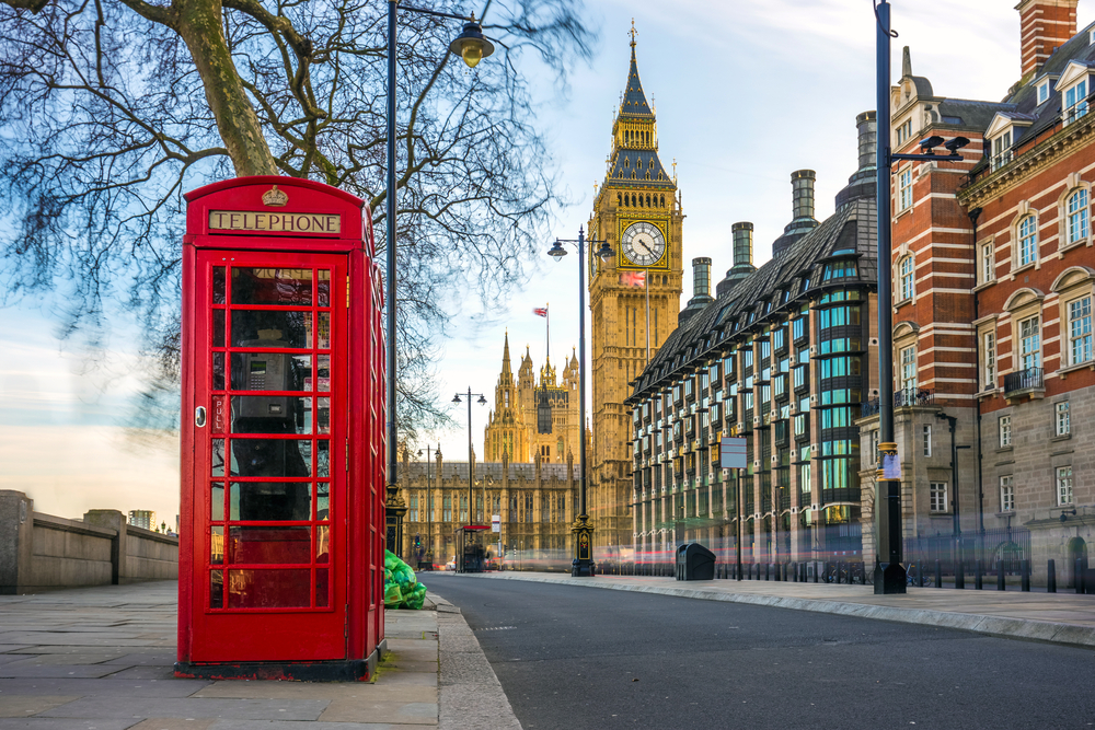 Red phone booth next to a street with Big Ben in the background during 5 days in London.