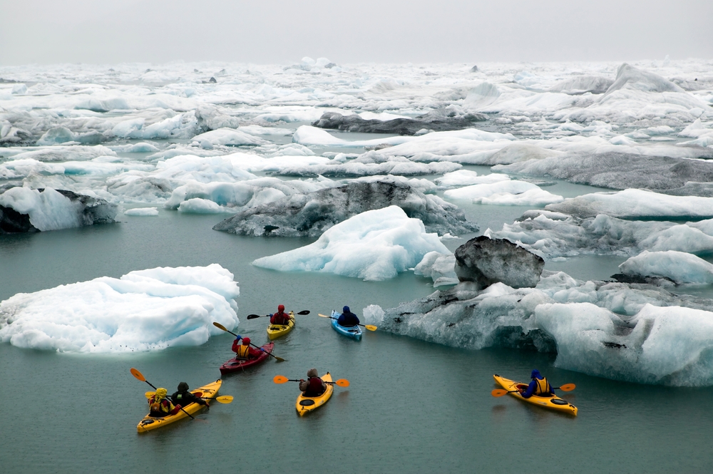 people kayaking between ice bergs anchorage to seward