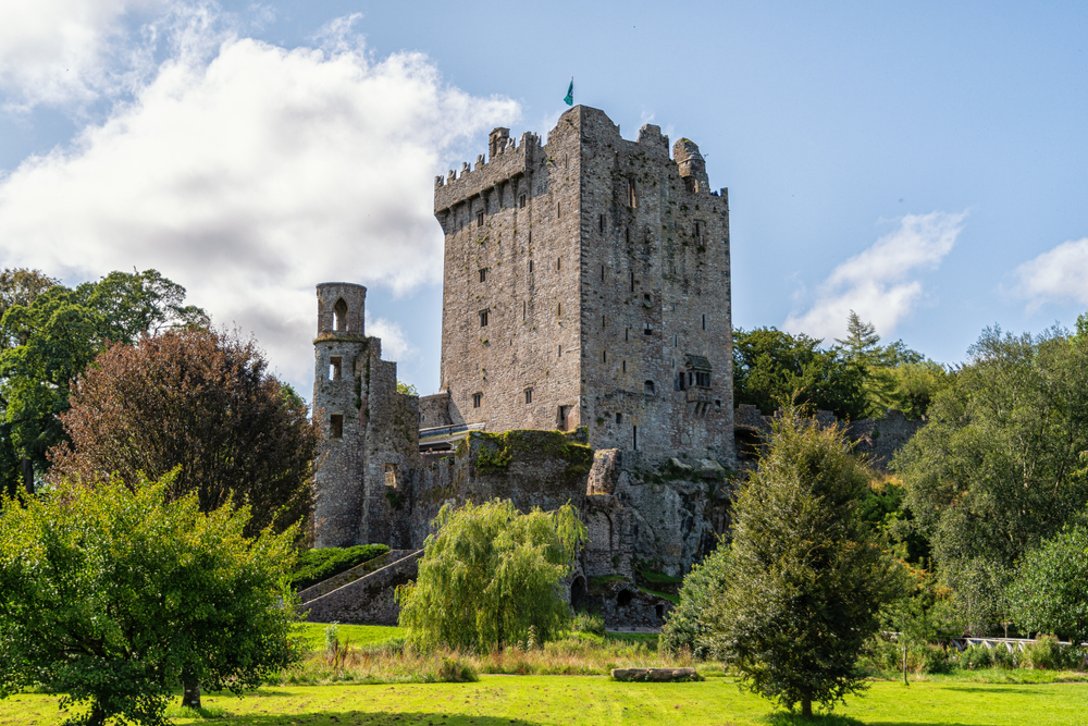 old castle ruin surrounded by trees kiss the blarney stone