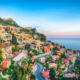 view of a coastal mountain town overlooking the sea things to do in taormina