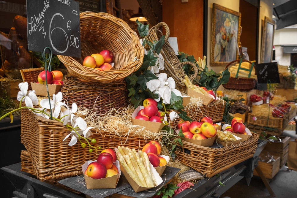 Rue Cler Market stall with baskets of apples.