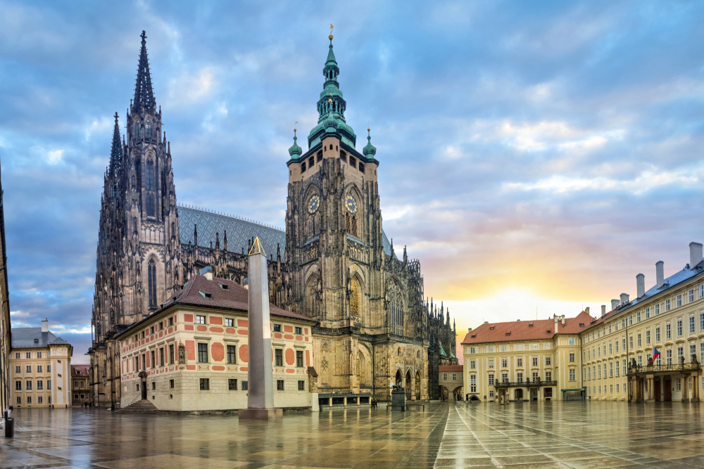 Sunrise at St. Vitus Cathedral with Gothic architecture.