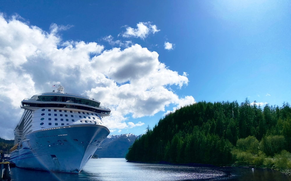 Alaska cruise ship dwarfed by the size and natural beauty of the wild Alaskan landscape. 