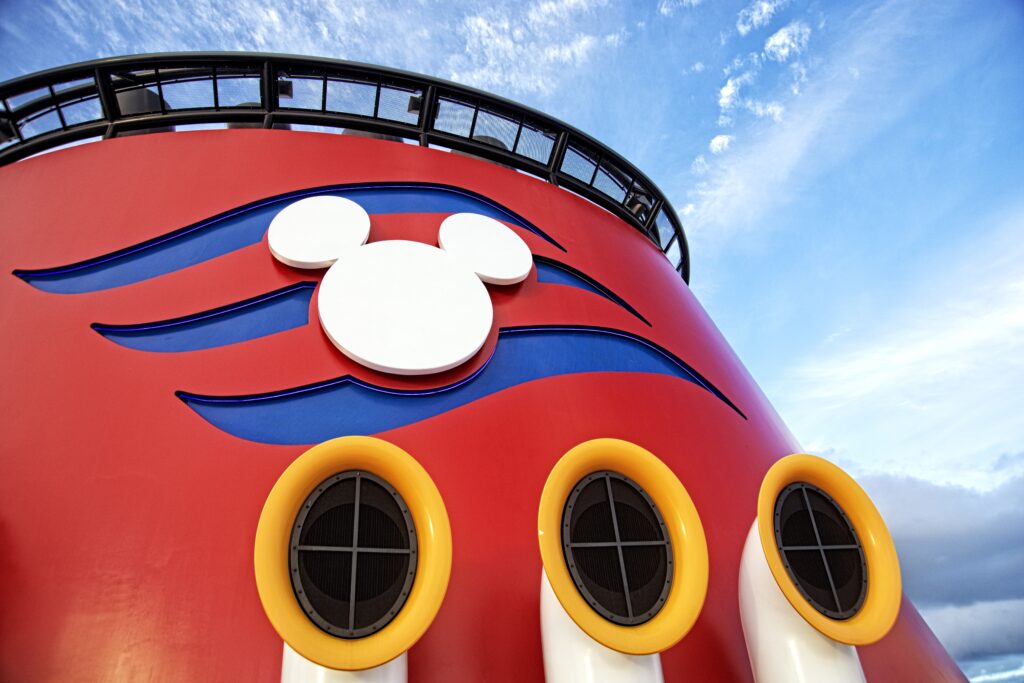 Close up of red Disney cruise smoke stack with white Mickey emblem.-