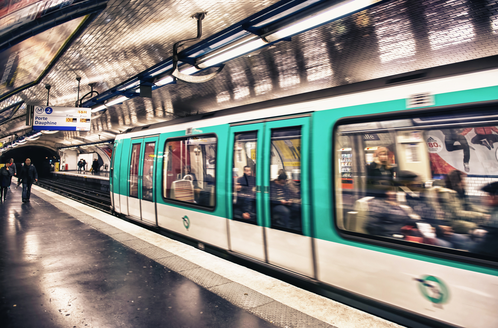 Paris Metro station showing a train slightly blurred. The article is about your first time in Paris. 