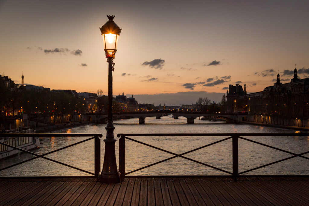 river with fancy streetlight  illuminated by dusk bridges in Paris
