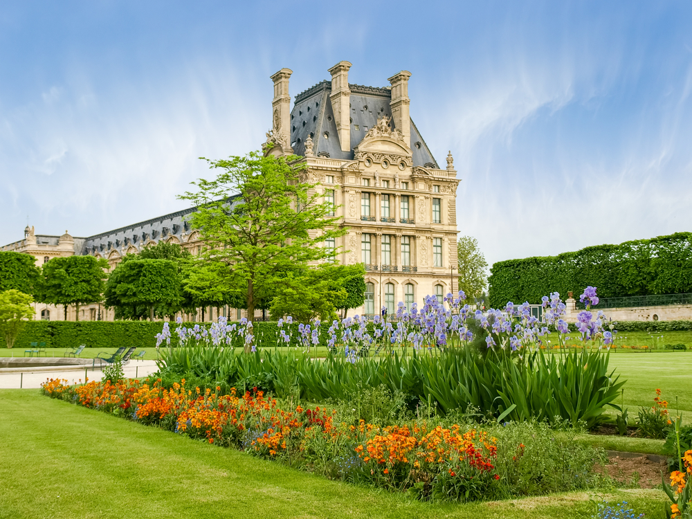 The Jardin des Tuileries next to the Louvre Museum with colorful flower beds.