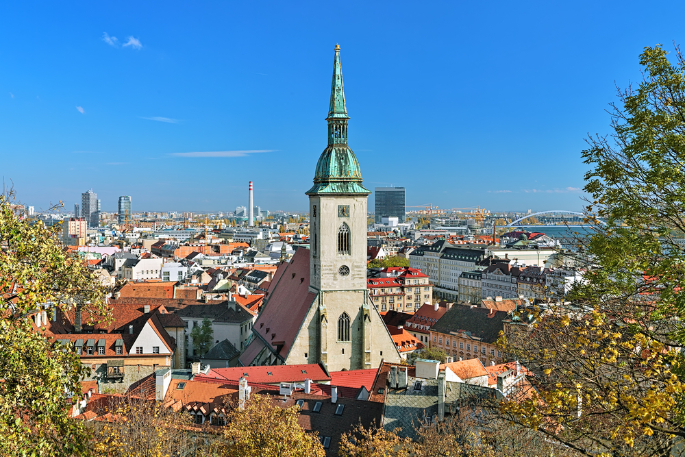 City view of church with tall green steeple Bratislava attraction